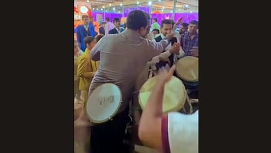 Wedding guests in Hyderabad protesting with drums during a celebration.