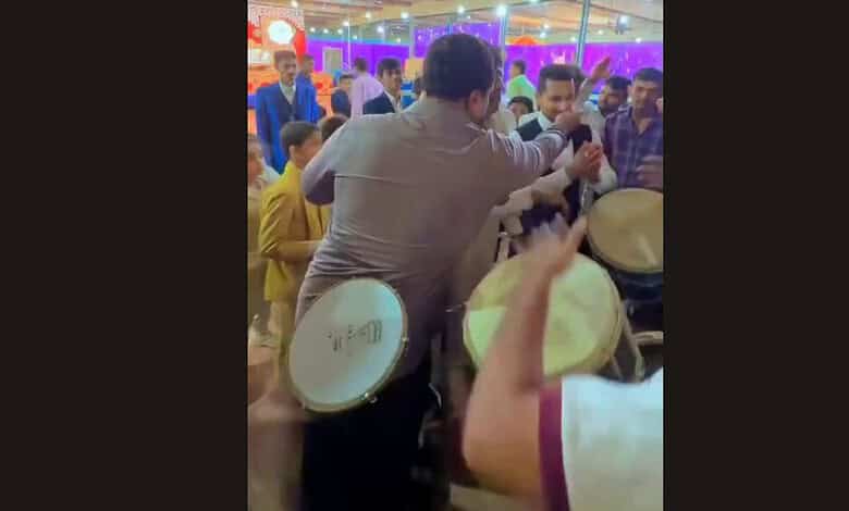 Wedding guests in Hyderabad protesting with drums during a celebration.