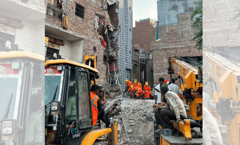 Rescue operation at building collapse site in Seemapuri, Delhi with firefighters and heavy machinery.