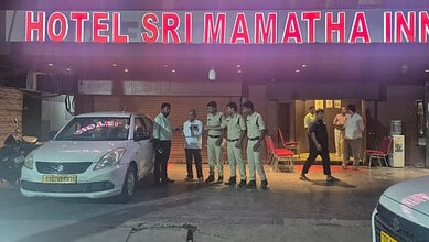 Police officers and officials outside Hotel Sri MAMATHA INN during a raid in Telangana.
