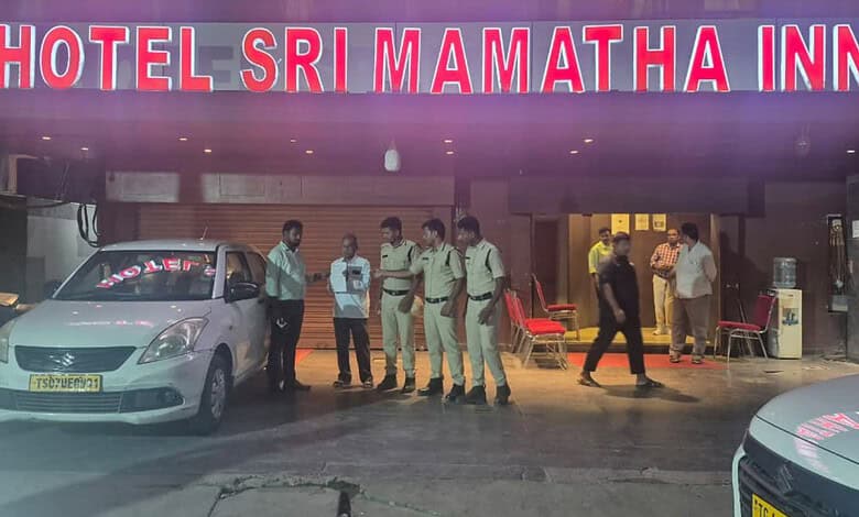 Police officers and officials outside Hotel Sri MAMATHA INN during a raid in Telangana.