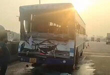 Damaged bus after collision on Hyderabad outskirts during sunset.