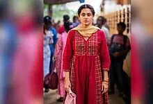 Taapsee Pannu in a red traditional dress at a public event in India.
