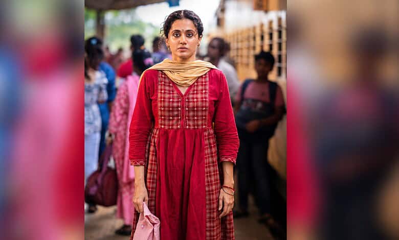 Taapsee Pannu in a red traditional dress at a public event in India.