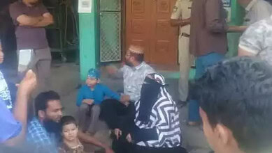 Protest outside husband's home with women and children gathered in Telangana, India.