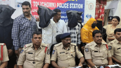 Police officers and suspects at Tolichowki police station during a trafficking operation.
