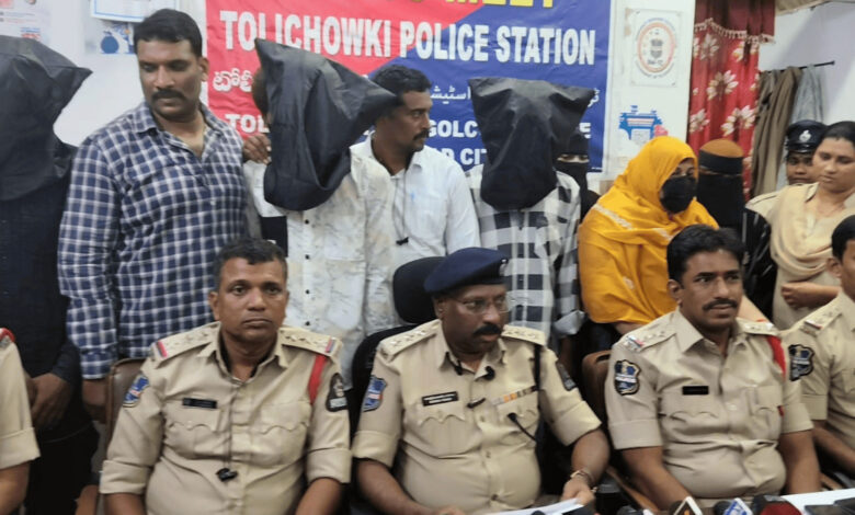 Police officers and suspects at Tolichowki police station during a trafficking operation.