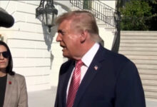 Former US President Donald Trump speaking outdoors during a public event.