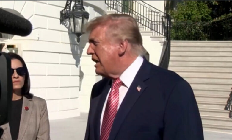 Former US President Donald Trump speaking outdoors during a public event.