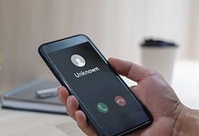 Mobile phone displaying an incoming call from an unknown caller.