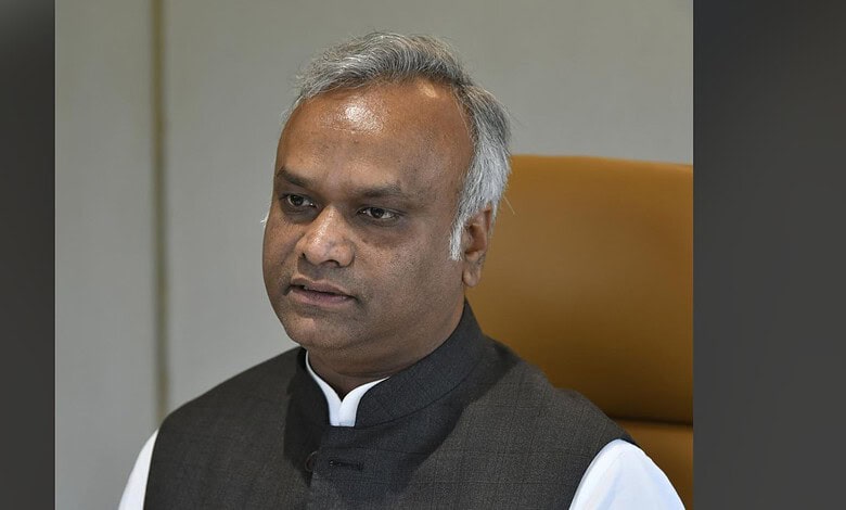 Priyank Kharge in a formal setting, wearing a black vest over a white shirt.
