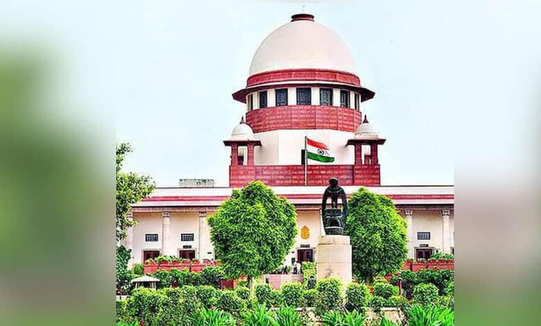 Supreme Court of India building with Indian flag and lush greenery in front.