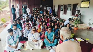 Large group of students attending a lecture or seminar in an indoor setting.