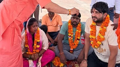 Family members embracing Hinduism during a ceremony in Uttar Pradesh, India.