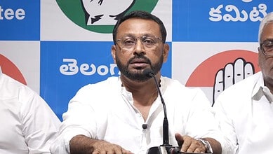 Political leader speaking at a press conference in Hyderabad with Telangana and TRS logos in background.