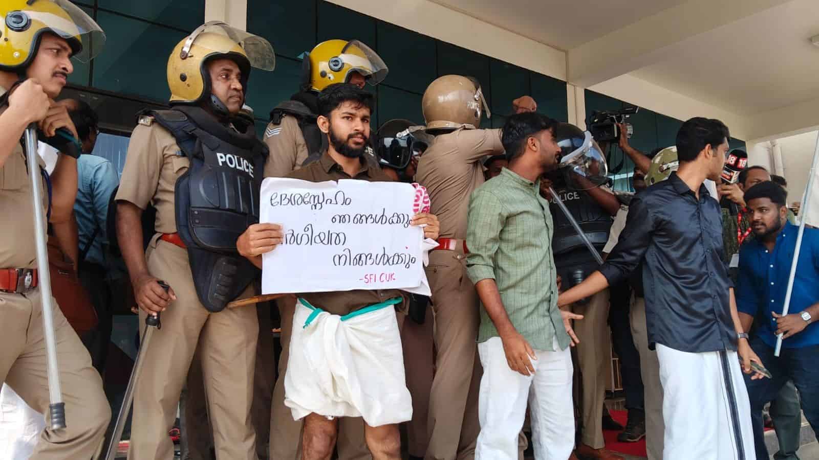 Protesters and police officers at Central University of Kerala during a demonstration.