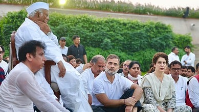Congress leaders gathered at Rajghat for a protest against election vote theft, sitting on the grass.