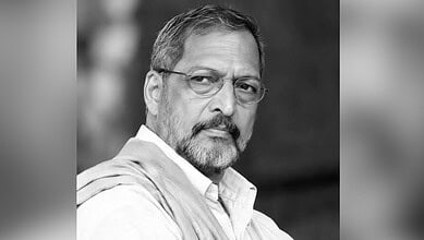 Black and white portrait of Nana Patekar with glasses and a beard.