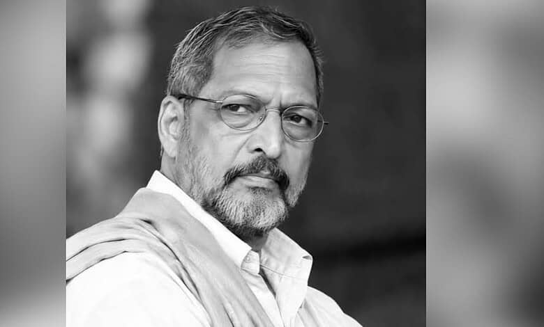 Black and white portrait of Nana Patekar with glasses and a beard.