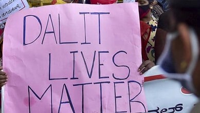 Protest sign reading 'Dalit Lives Matter' held by demonstrators during a caste dispute protest.