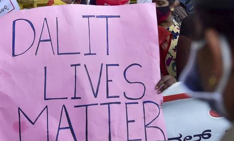 Protest sign reading 'Dalit Lives Matter' held by demonstrators during a caste dispute protest.