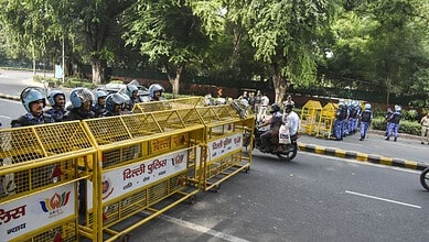 Protesters and police barricades at Jantar Mantar during a demonstration in India.