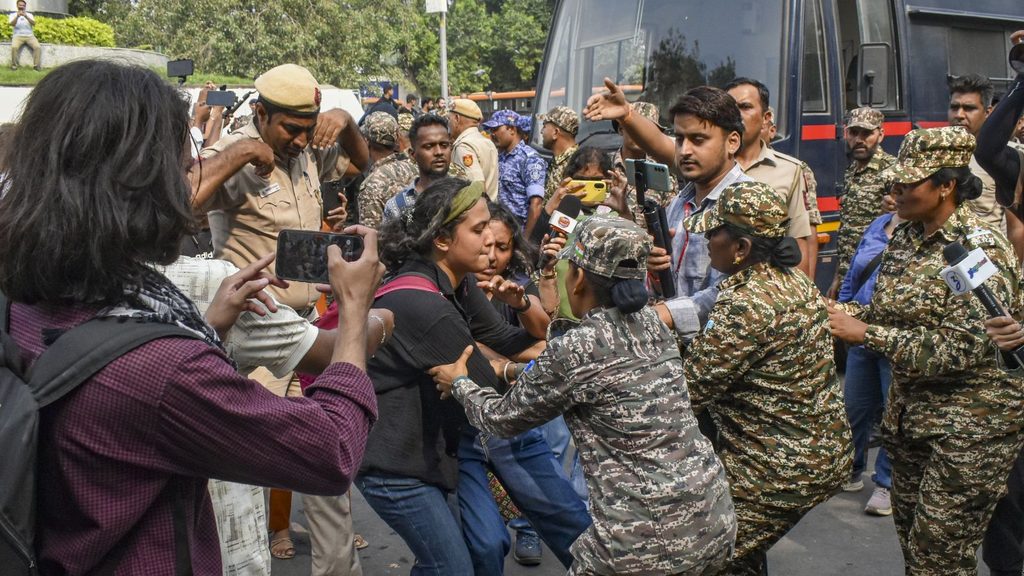 Clash between civilians and police officers during a protest in Delhi.