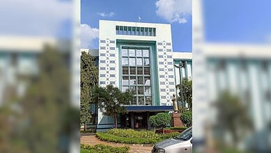 Osmania Medical College building with modern architecture and greenery in front.