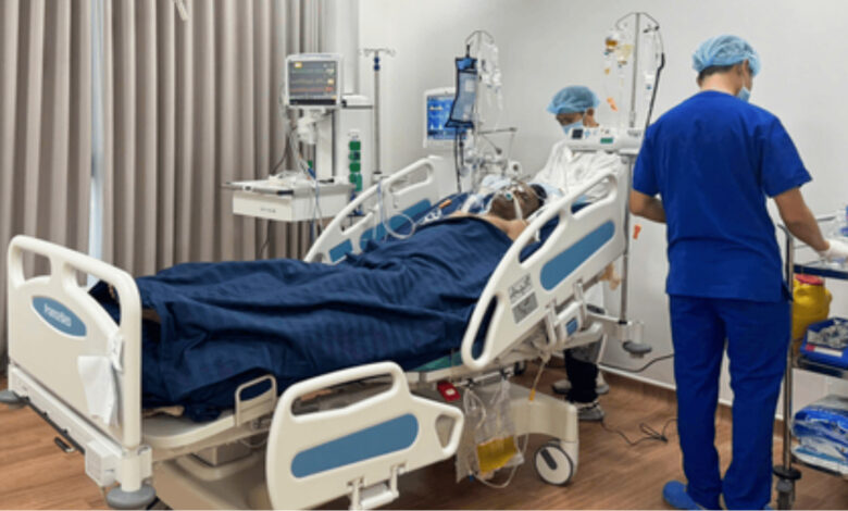 Hospital room with patient on bed and medical staff attending, underlines healthcare services.
