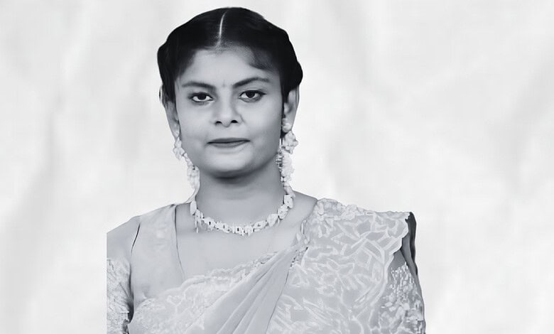 Black and white portrait of a woman in traditional attire with jewelry.