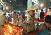 police personnel douse flames on the bike