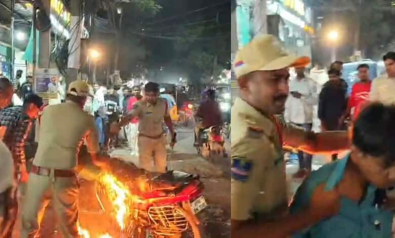 police personnel douse flames on the bike