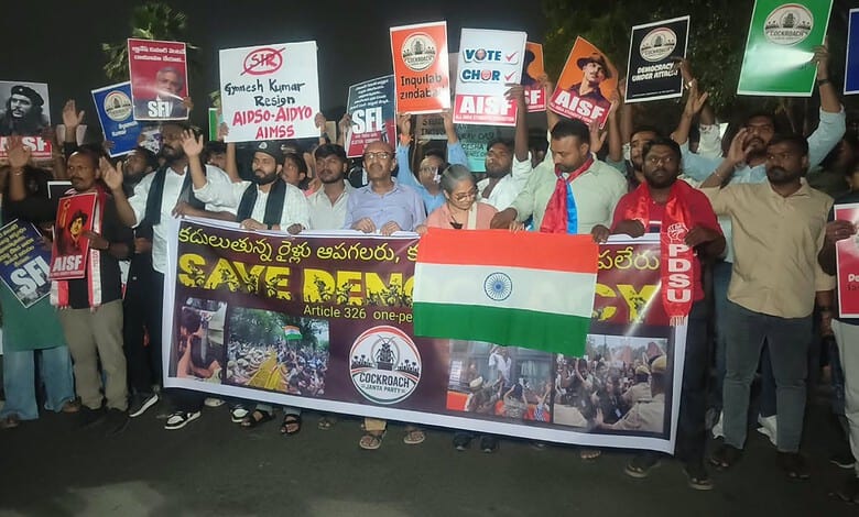 Students march in Hyderabad holding banners and the Indian flag during a protest.