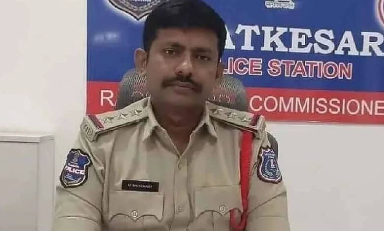 Hyderabad police inspector in uniform at police station with badge and insignia.