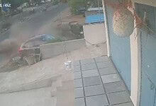 Car crashes into roadside wall, causing dust and debris in Karimnagar, India.