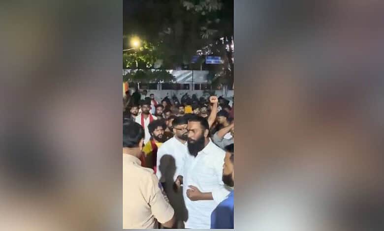 Crowd gathered at Dandiya event in Hyderabad's Begumpet, with some people raising hands and engaging in a.