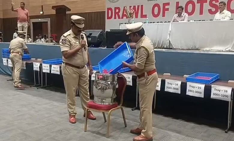 Police officers conducting a lucky draw event for bars in Telangana.