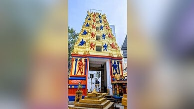 Colourful temple tower with statues and decorations, bright and vibrant in appearance.