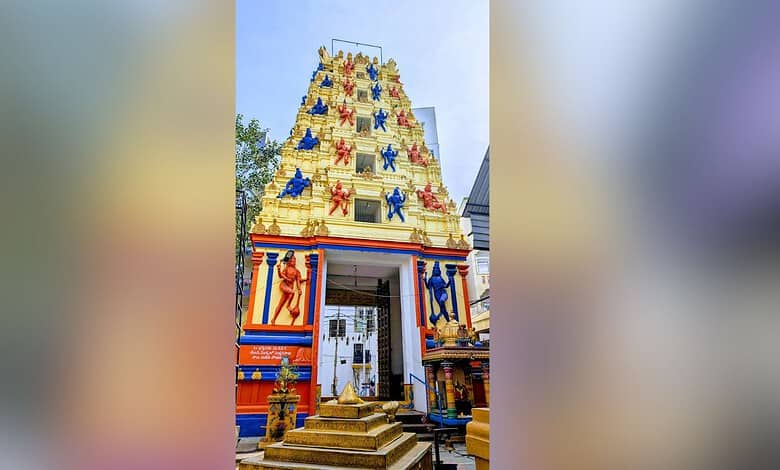 Colourful temple tower with statues and decorations, bright and vibrant in appearance.