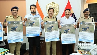 Hyderabad police officials hold posters during a campaign against Indian Roller display.