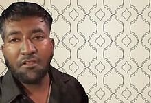 Man speaking in front of patterned background at MSVR Dandiya Muslim bouncer event.