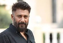 Vivek Agnihotri with a serious expression outdoors, wearing a black shirt.