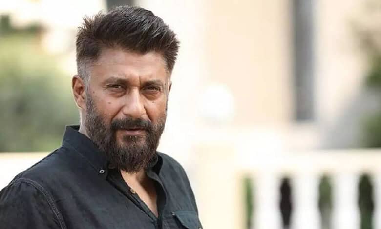 Vivek Agnihotri with a serious expression outdoors, wearing a black shirt.