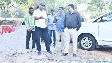GHMC officials inspect steel flyover project site in Hyderabad during daytime.