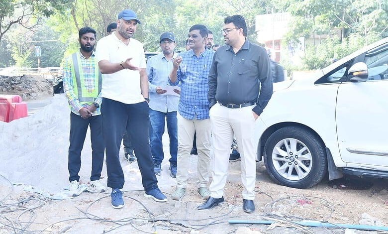 GHMC officials inspect steel flyover project site in Hyderabad during daytime.