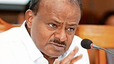 Kumaraswamy speaking passionately during a press conference or meeting.