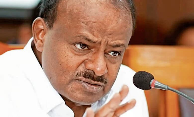 Kumaraswamy speaking passionately during a press conference or meeting.