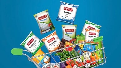 Assorted Dodla Dairy products in a shopping cart against a blue background.