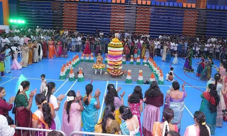 Celebration of Bathukamma festival with women in colourful traditional attire in Dubai.