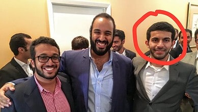 Group of young men in formal attire smiling and celebrating at a social gathering.